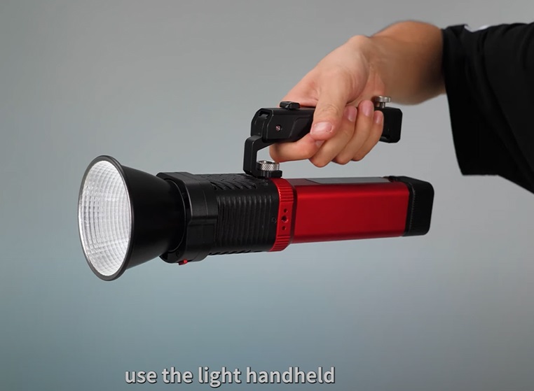 Portable Spotlight: Your Key to Mastering Hard Light Portrait Photography 5 Hand holding a portable spotlight.
