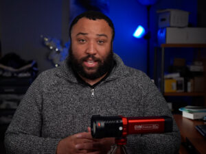 The Ultimate Product Photography Lighting Setup & Tips 9 Image capturing a creator during a review or tutorial, analyzing the portable spotlight.