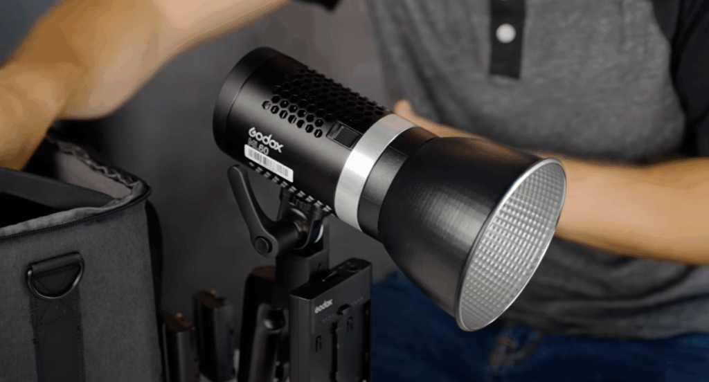 The Ultimate LED Studio Light Guide for Videographers & Photographers (2025) 5 Close-up of the portable Godox ML60 LED studio light, highlighting its compact design and ergonomic grip handle for run-and-gun filmmaking.