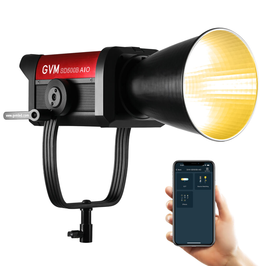 A GVM SD500B AIO LED light with a reflector and a hand holding a smartphone control app. This image highlights the light's versatile Bowens mount and wireless control, ideal features for a flexible light for video recording.