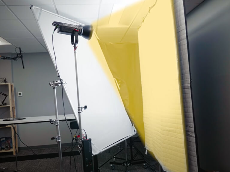 GVM SD300B-AIO: Your All-in-One 300W LED Video Light 7 A powerful 300W LED video light set up in a studio with a large softbox and diffusion panel, demonstrating its capability to create broad, soft illumination for professional shoots.