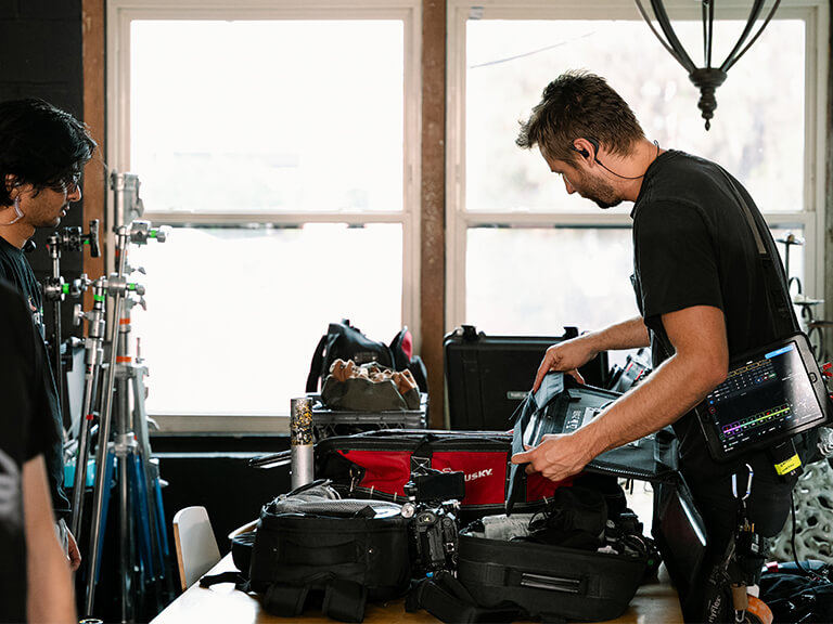 From Compact to Custom: Exploring the GVM Z100B 100W Portable Light 7 Professional videographer setting up GVM Z100B 100W portable light on location for a shoot.