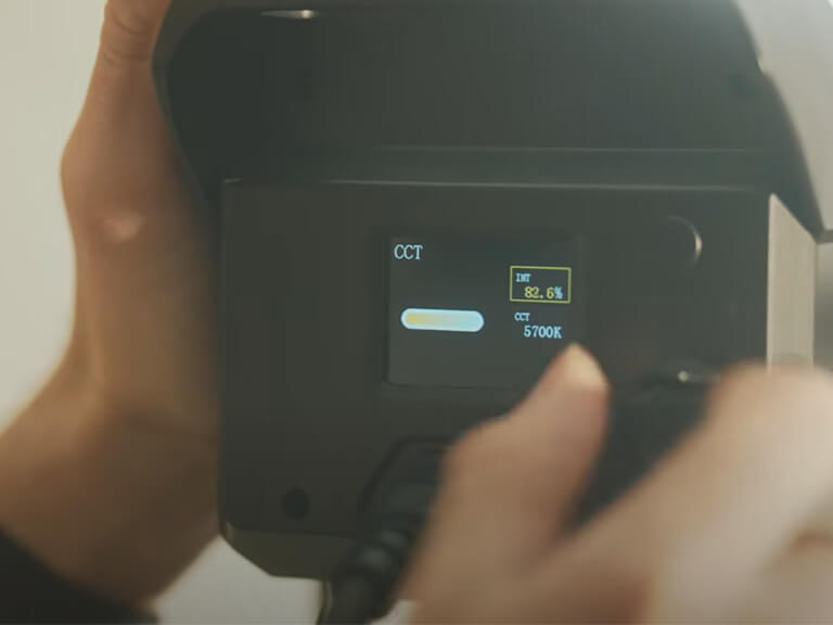 GVM SD300B-AIO: Your All-in-One 300W LED Video Light 2 Close-up of a hand intuitively adjusting the Color Temperature (CCT) on the GVM SD300B-AIO's built-in control screen. This all-in-one 300W LED video light streamlines workflow and saves crew time.