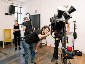A dynamic view of a professional video production set, showcasing high-end video lighting and camera equipment in action, symbolizing the mastery of craft discussed in the article on essential lighting parameters.