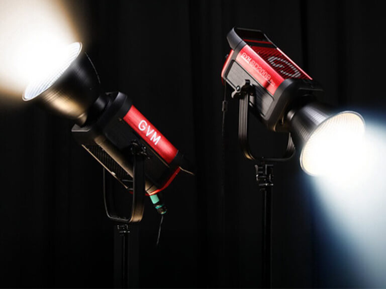 Say Goodbye to Flat & Shadowy Photos! A Beginner's Guide to Photography Lighting 1 Two GVM brand LED studio photography lights brightly illuminated on stands against a dark background, demonstrating their powerful light output.
