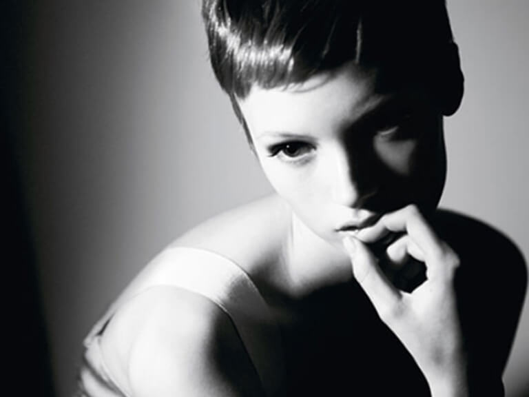 Say Goodbye to Flat & Shadowy Photos! A Beginner's Guide to Photography Lighting 9 Black and white portrait featuring classic Rembrandt photography lighting, creating a dramatic interplay of light and shadow, characteristic of studio illumination.