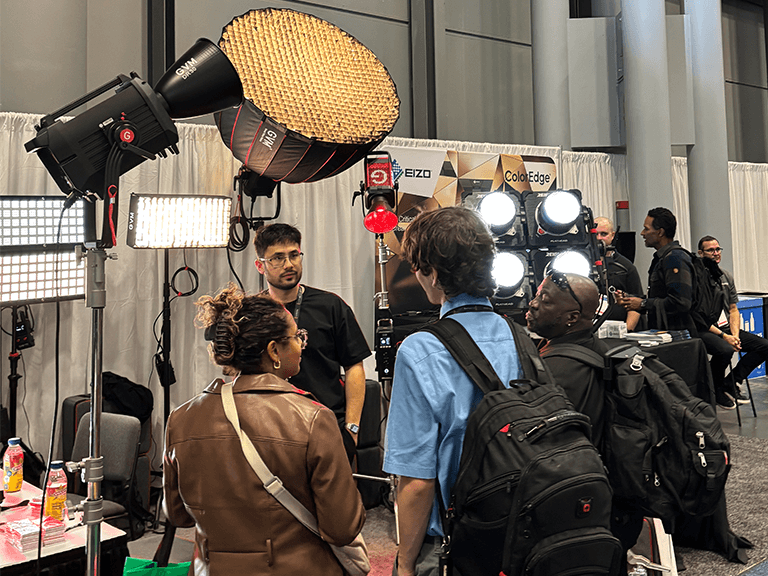 NAB Show New York Highlights: GVM's Breakthrough in LED Lighting 2 Visitors engaging with GVM's newly launched Reign R1200B 1200W Bi-Color COB Light and other professional cinema lighting solutions at their NAB Show New York booth.