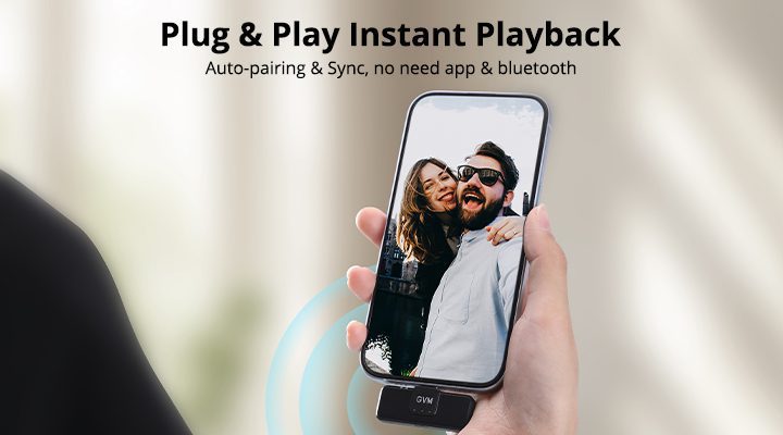 Vlogger holding a smartphone with the GVM CM2 wireless lavalier microphone receiver plugged into the USB-C port for instant recording.