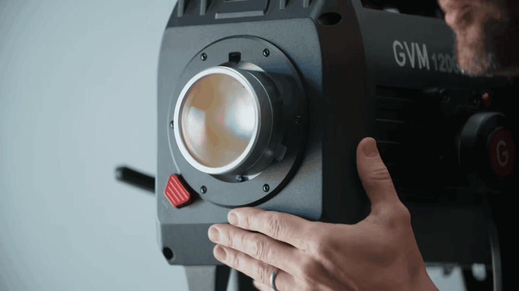 Best Lighting for Filmmaking 2026: GVM 1200B AIO Full Review 4 Attaching the 3x optical intensifier to the GVM 1200B AIO Bowens mount lighting for filmmaking.