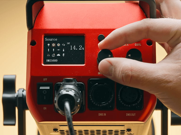 Professional Photography Lighting interface featuring an LCD display with various source presets, DMX IN and DMX OUT ports, and manual control knobs for precise studio lighting adjustments.