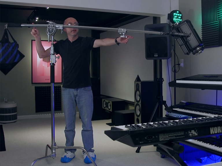 Wind, Sand, and Uneven Concrete: How to Choose a Light Stand for Location Shoots 3 Professional C-stand lighting setup with a boom arm and sandbag counterbalance for maximum load capacity and height stability.